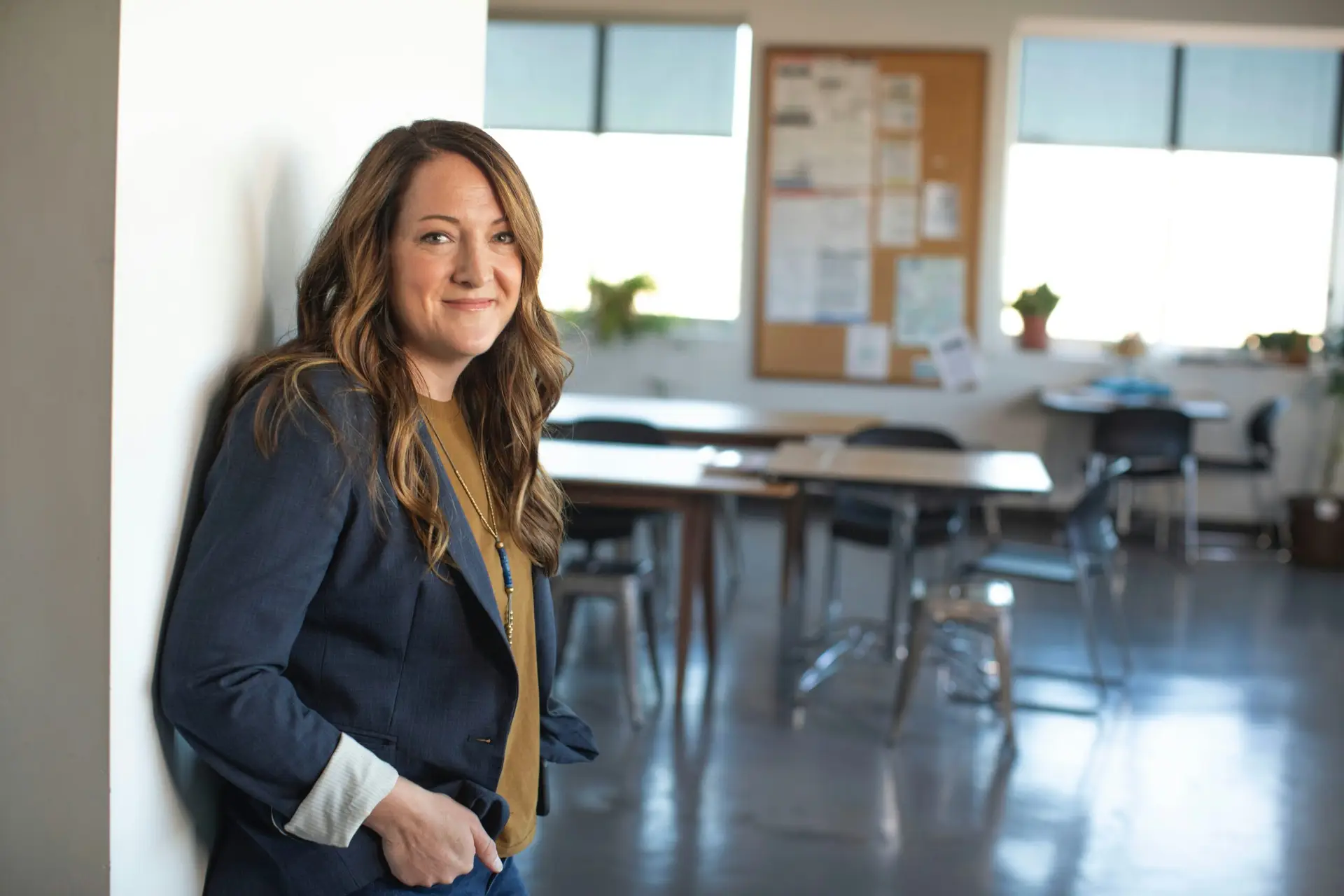 Female teacher in front of empty classroom